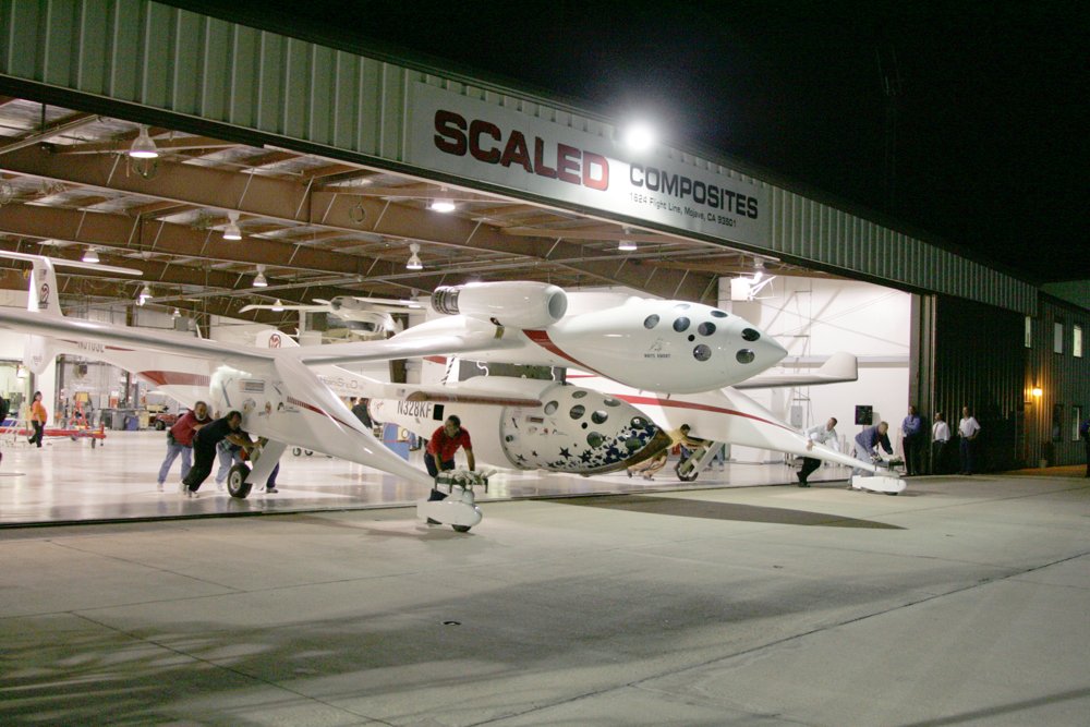 The team pushes White Knight and SpaceShipOne out of the Scaled Composites hangar at night