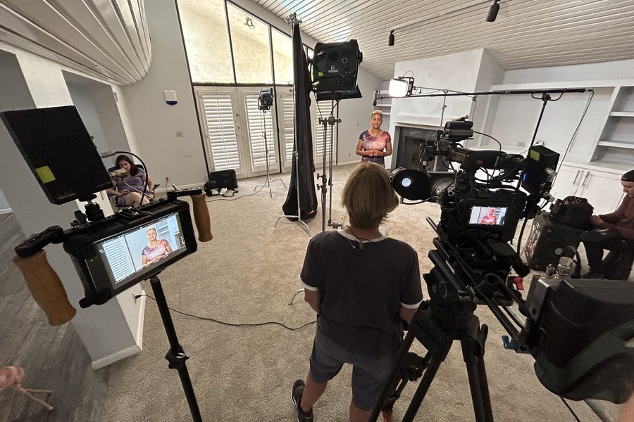 A multi-camera setup on a bright living-room set