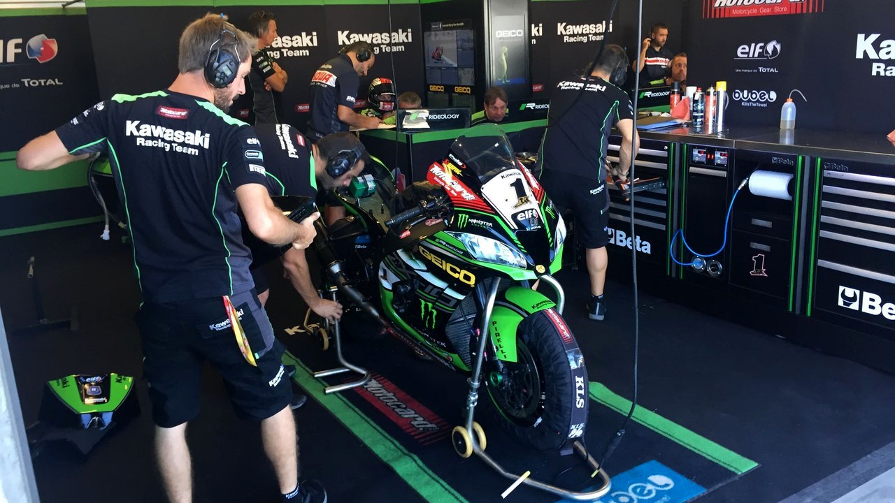 Kawasaki Racing Team mechanics prepare the number 1 bike in the Laguna Seca garage